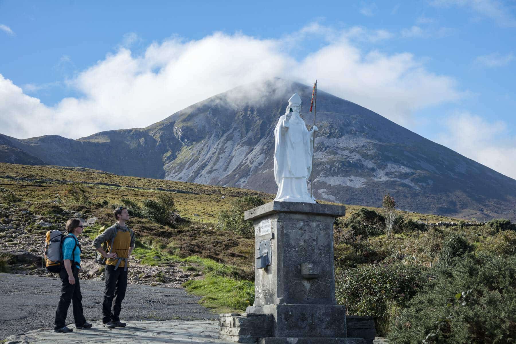 Walkers-pausing-at-statue-of-St-Patrick-at-foot-of-Croagh-Patrick-Co-Mayo_Web-Size-1-1